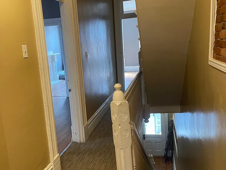 top floor hallway looking at door on left to the bedroom/office and the living toom area at the end of the hall