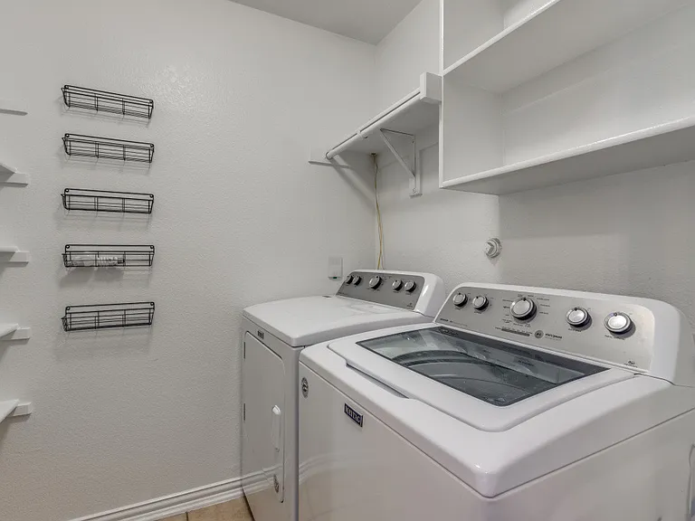 Laundry room with lots of shelves