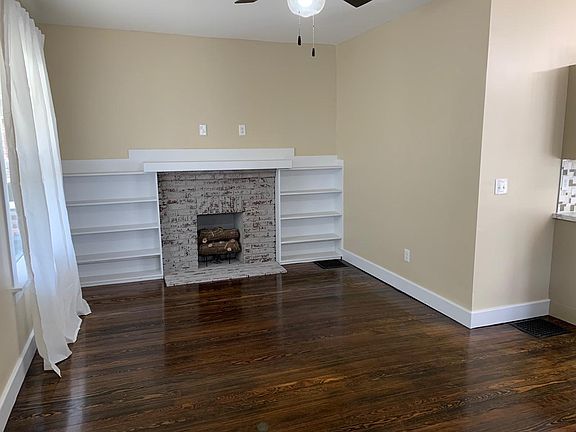 Living room with fireplace and built-in shelving