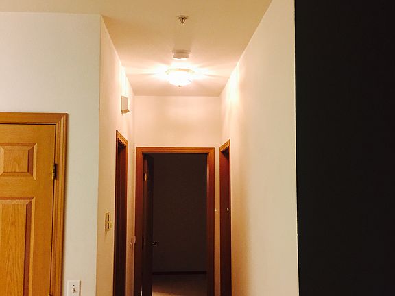 hallway leading to 2 bedrooms and bathroom