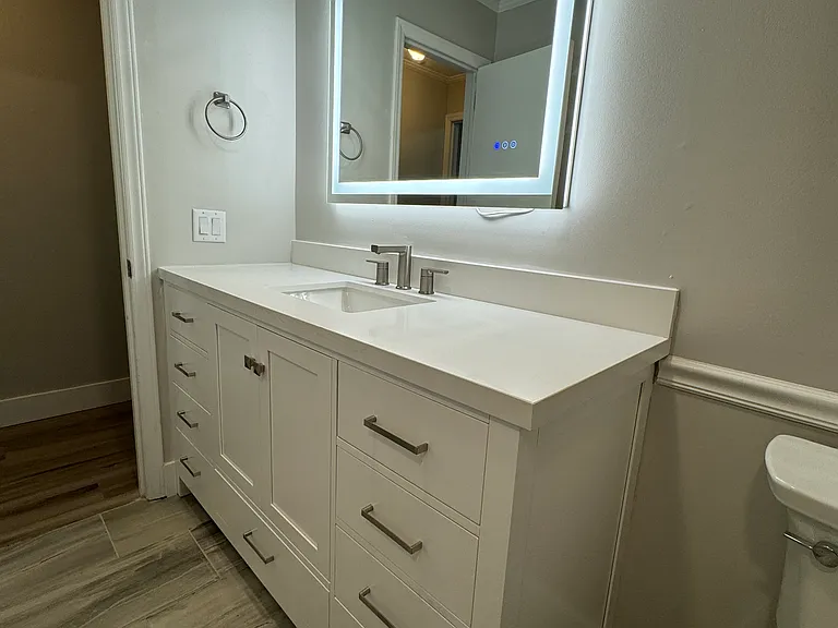 Brand new bathroom with LED lit mirror