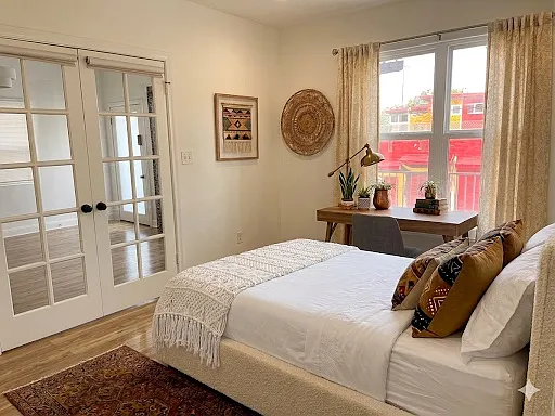 The front bedroom has French doors, a large closet and lots of natural light (Virtual Staging)