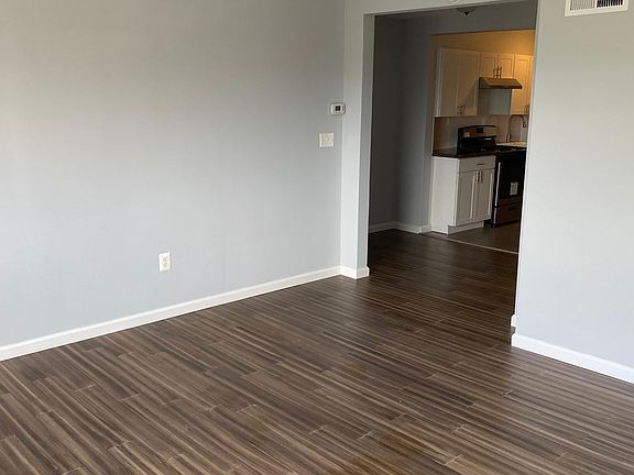 View of living room, breakfast nook and kitchen area.