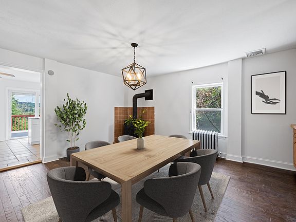 Dining Room With Wood-Burning Stove and Black Contemporary Chandelier!