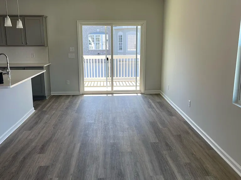 Open-air living area on main level with sliders out to marsh-view deck