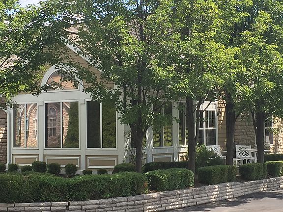 Sunroom in boxwood garden 
