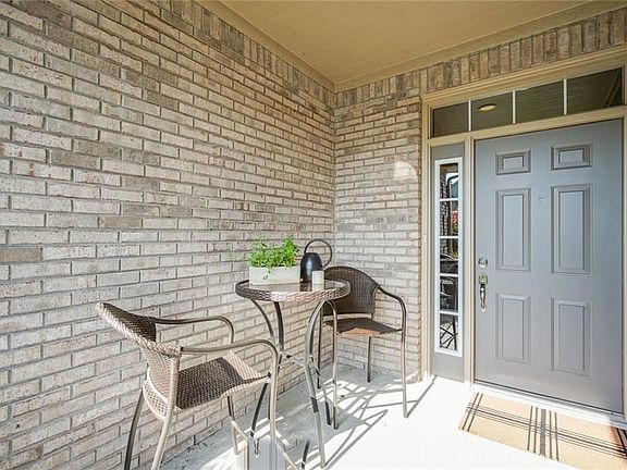 Covered porch at entry... a nice spot to relax and catch up with neighbors