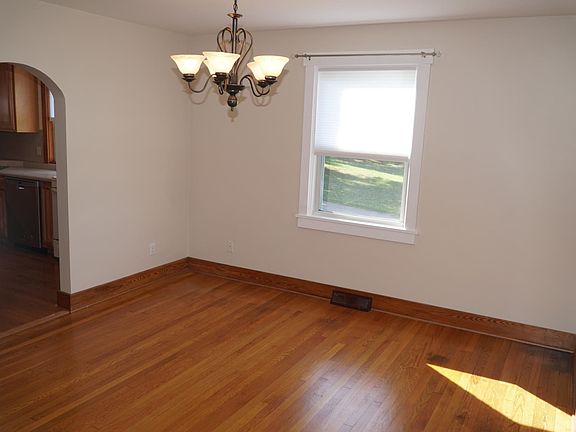 Bright dining room with hardwood floors and chandelier
