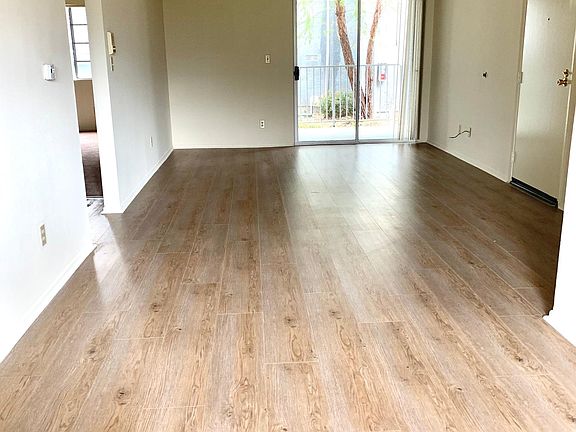 View from dining area in to living room. Patio located off of the living room overlooks the garden pathway.