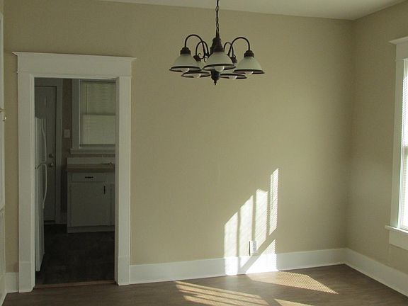 Dining room with hanging light for table area.