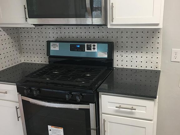 NEW STAINLESS STEEL GAS RANGE AND MICROWAVE