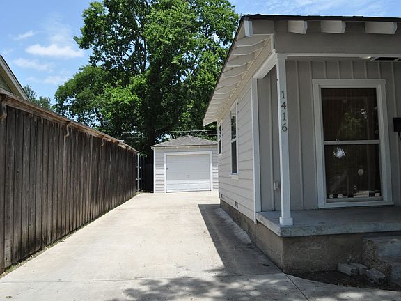 Circle driveway also leads to the side of the home showing the detached garage