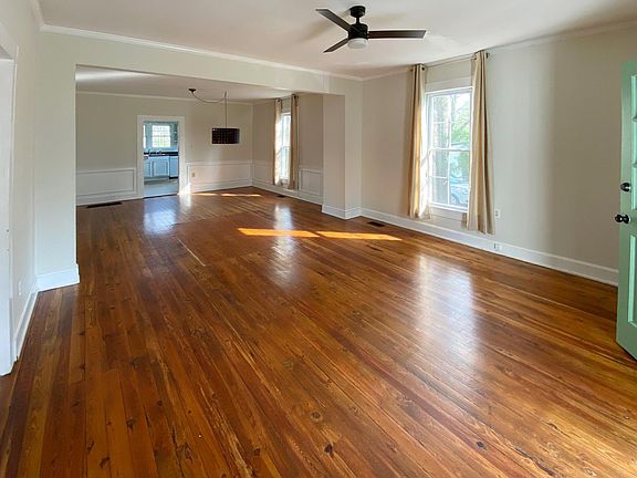 Open floor plan living and dining space with hardwood floors