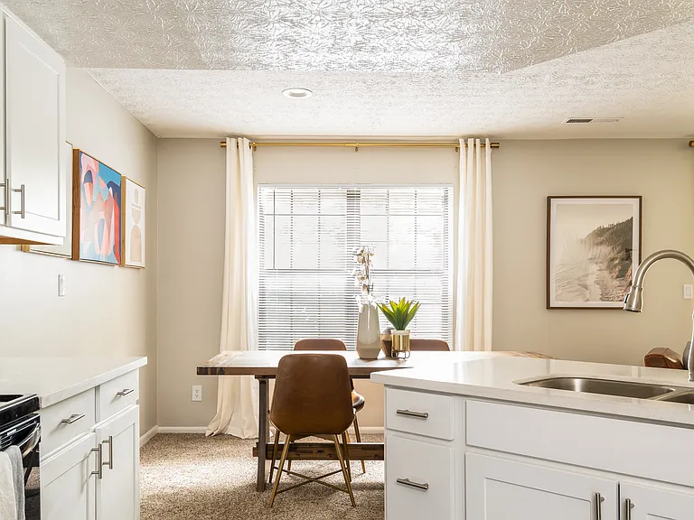 Dining Area with Plush Carpet and Kitchen with Granite Countertops