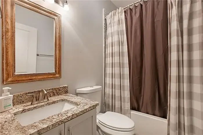 Guest Bathroom. It is a full bathroom with shower and tub.