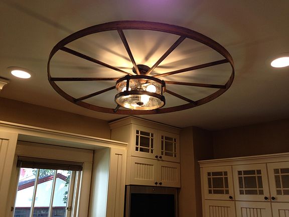Custom-made light fixture in kitchen; made from wagon wheel.