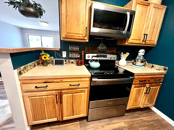 Warm wood cabinets and stainless steel appliances