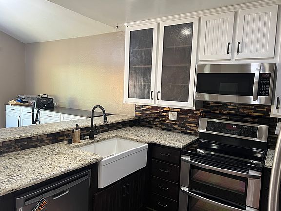 The kitchen has been completely remodeled and opens up to the dinning area and just off of the living area. There is a large farm style sink and stainless steel apliances.