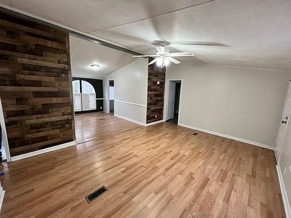 View of the living room looking at the dinning room, laundry room, and master bedroom.