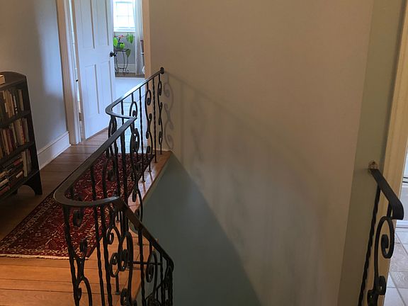 Upstairs hallway with curved staircase