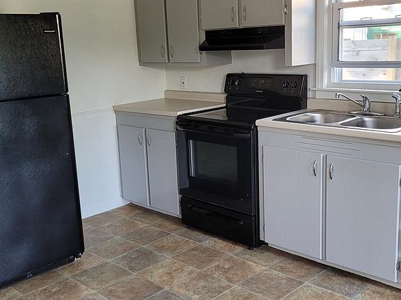 Electric range, recent paint, filtered water at kitchen sink.
