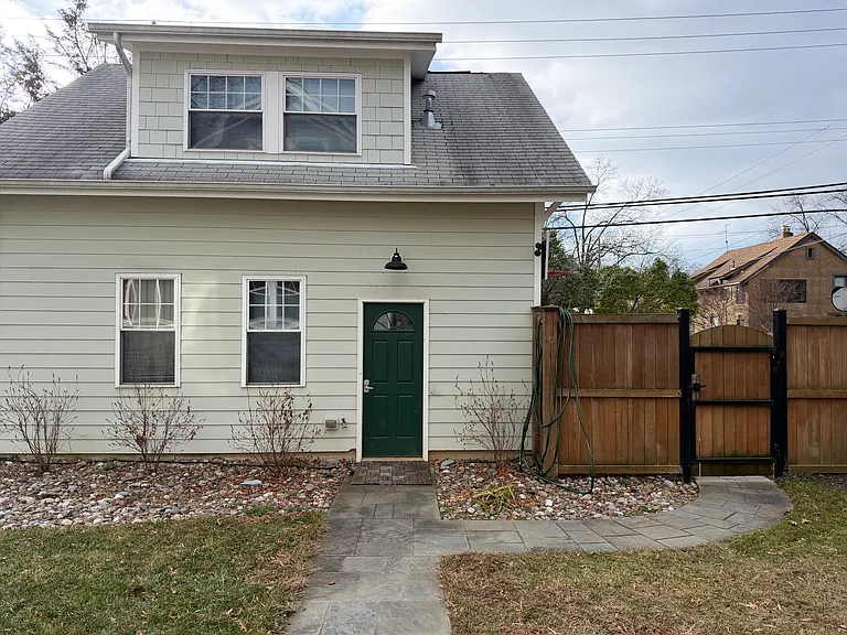 You enter through the back gate and use your code to enter the garage and another code to go up the stairs