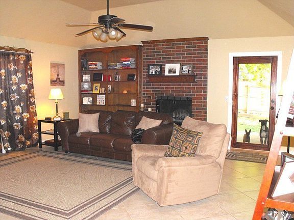Large living room with built-in bookshelves.  Tiled floor - beautiful!