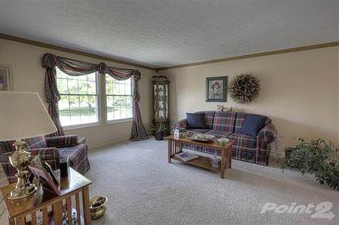 The great room is flooded with natual light that pours throught the large double view windows. The space of this room is comfortable and offers plush clean carpet and crown molding accents throughout.