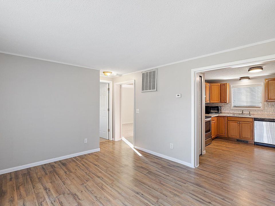 view from entry door. Living room and kitchen. Small hall with 2 bedrooms and a bathroom in back