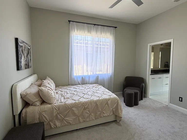 Bedroom featuring ceiling fan and shared Jack-and-Jill bathroom