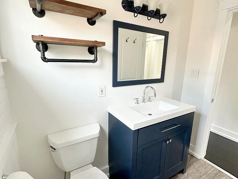 Front bathroom, updated vanity, shower/tub combo, subway tile, toilet
