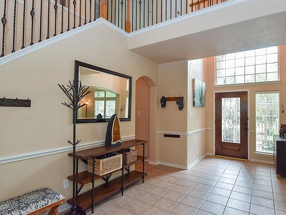 Enter through the leaded glass front door to a 2 story entry and oversized front tiled hallway that allows plenty of natural light into the home.