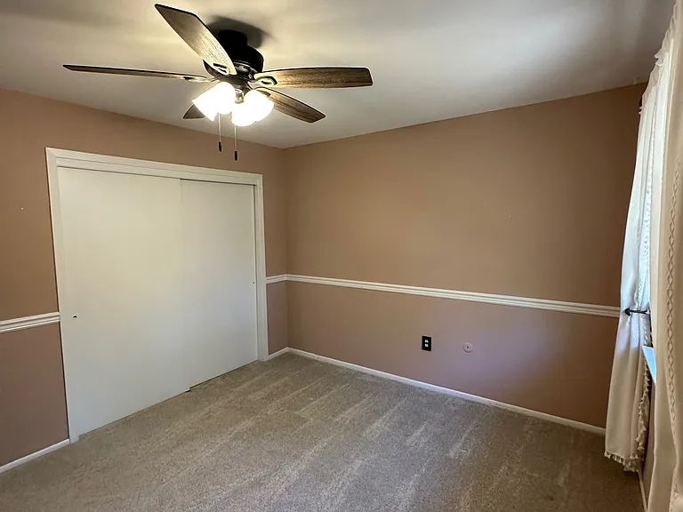 Large second bedroom on second floor with beautiful window overlooking backyard and deck.