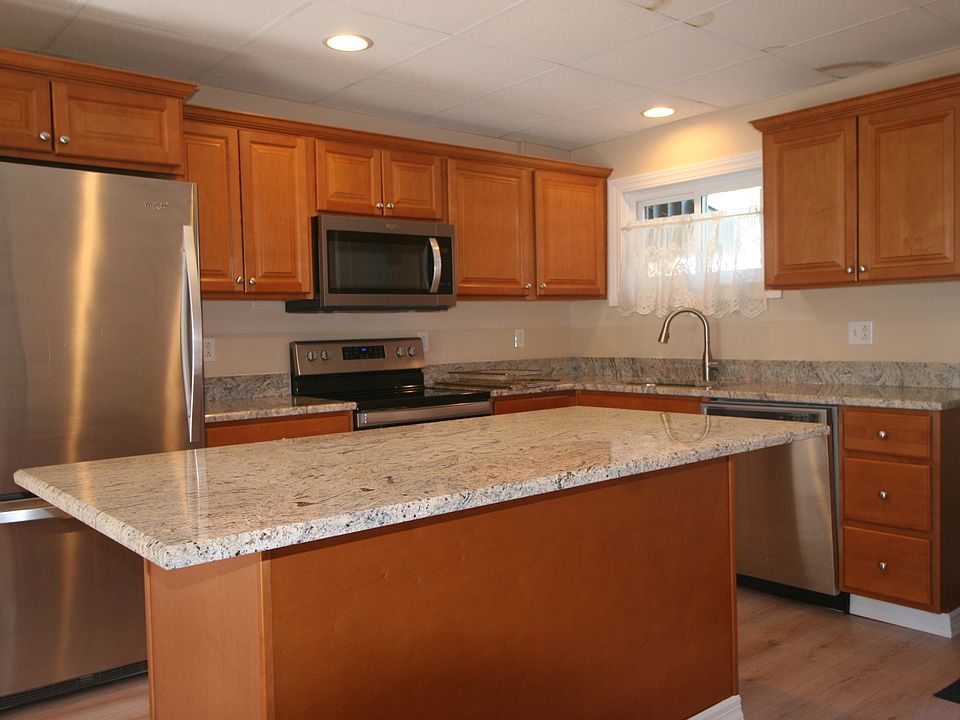 Lovely rencently renovated kitchen with stove, refrigerator, microwave and dishwasher.
