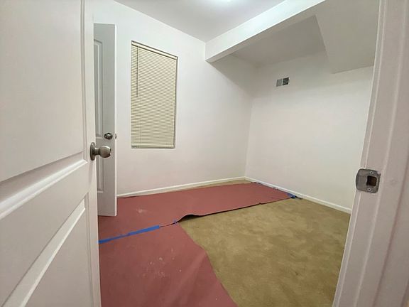 This is the bedroom, with protective paper over the carpet to keep it clean.