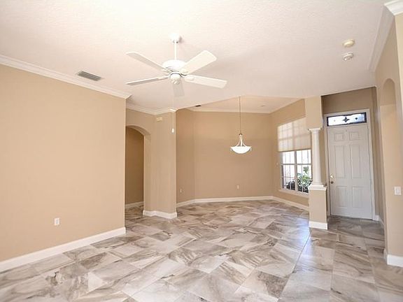 Over 2,400 sf of living space with new porcelain tile, fresh paint, crown molding, and more.