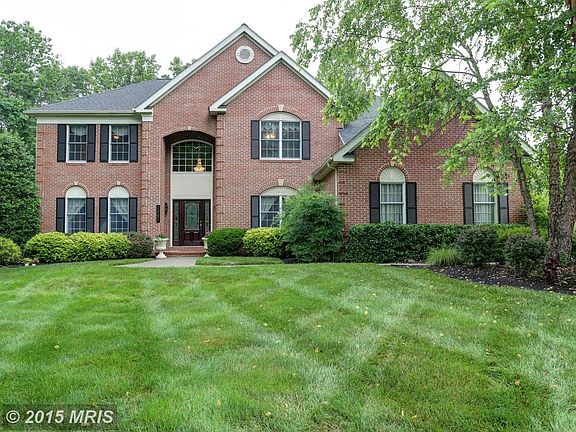Brick front colonial sited on a large wooded lot