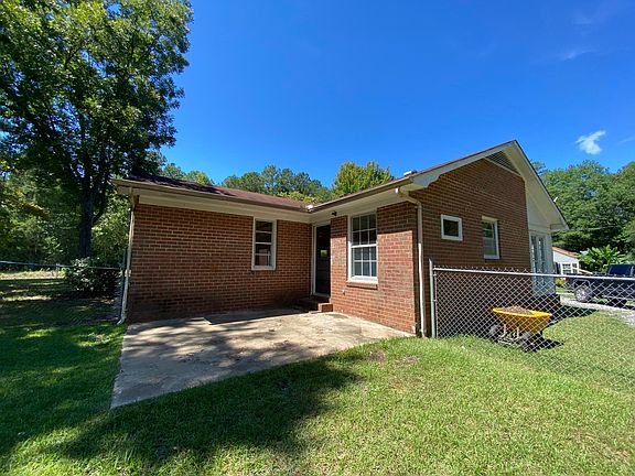 back side of the house and back door to kitchen and fenced yard