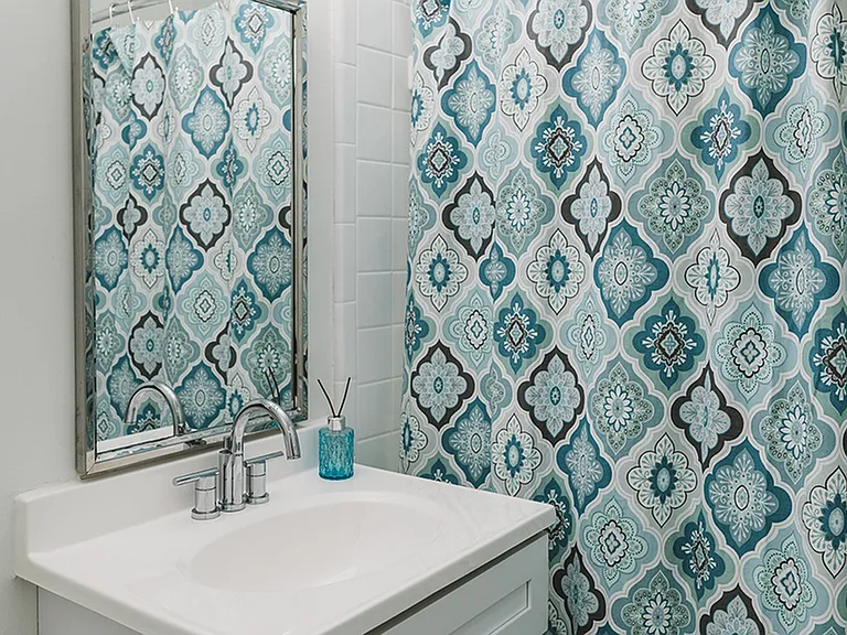Quartz countertops with framed vanity add the finishing touch