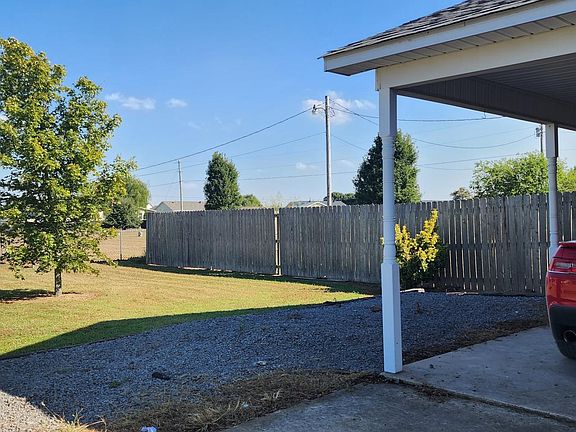 Carport with extra gravel parking spaces