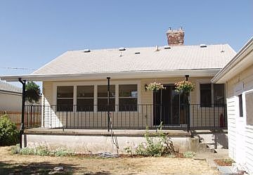 Back covered patio with large fenced yard