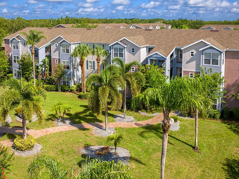 Ashton Chase offers resort-style living with lush greenery, winding brick walkways, and serene views from every apartment.