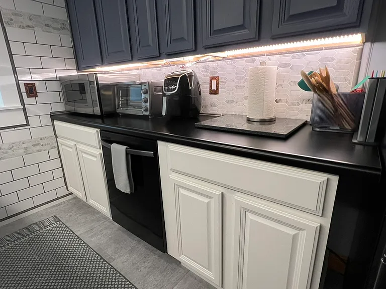 Newly remodeled kitchen. Full size microwave. Toaster oven. Air fryer. Dishwasher. All dishes, pots/pans, silverware, knives, utensils, kitchen towels/pot holders/storage containers provided. Bright under counter lighting. Tiled walls throughout kitchen.