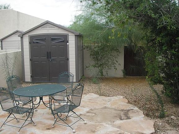 Private backyard with storage shed.