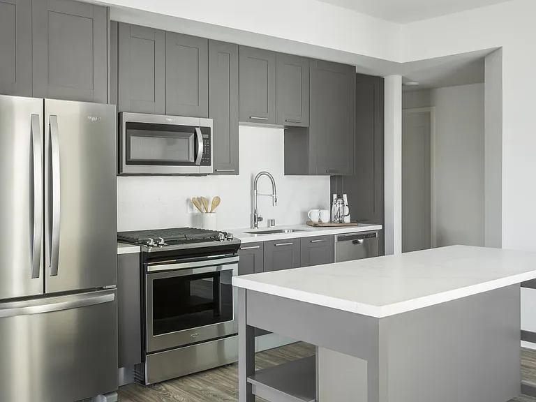 Sleek shaker cabinetry with stainless steel appliances and quartz countertops.