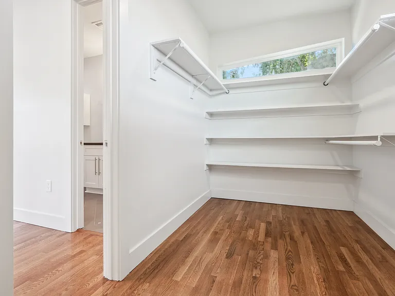 Gigantic walk-in master closet with custom shelving.