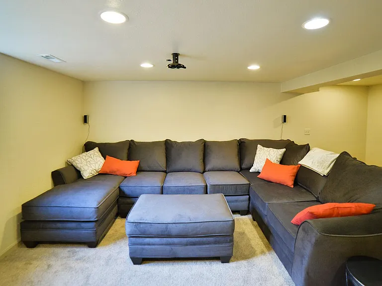Basement living room with smart tv and surround sound.