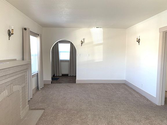 Looking towards the entry. Non-working fireplace.