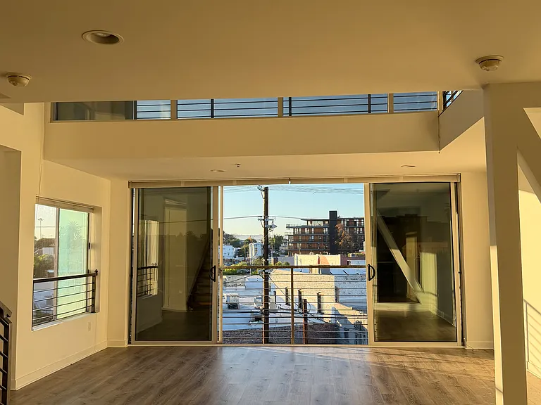 Double height space with open balcony doors!
