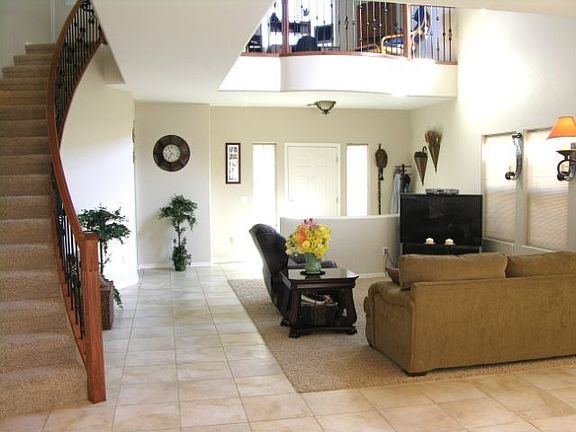living room with iron stair rail